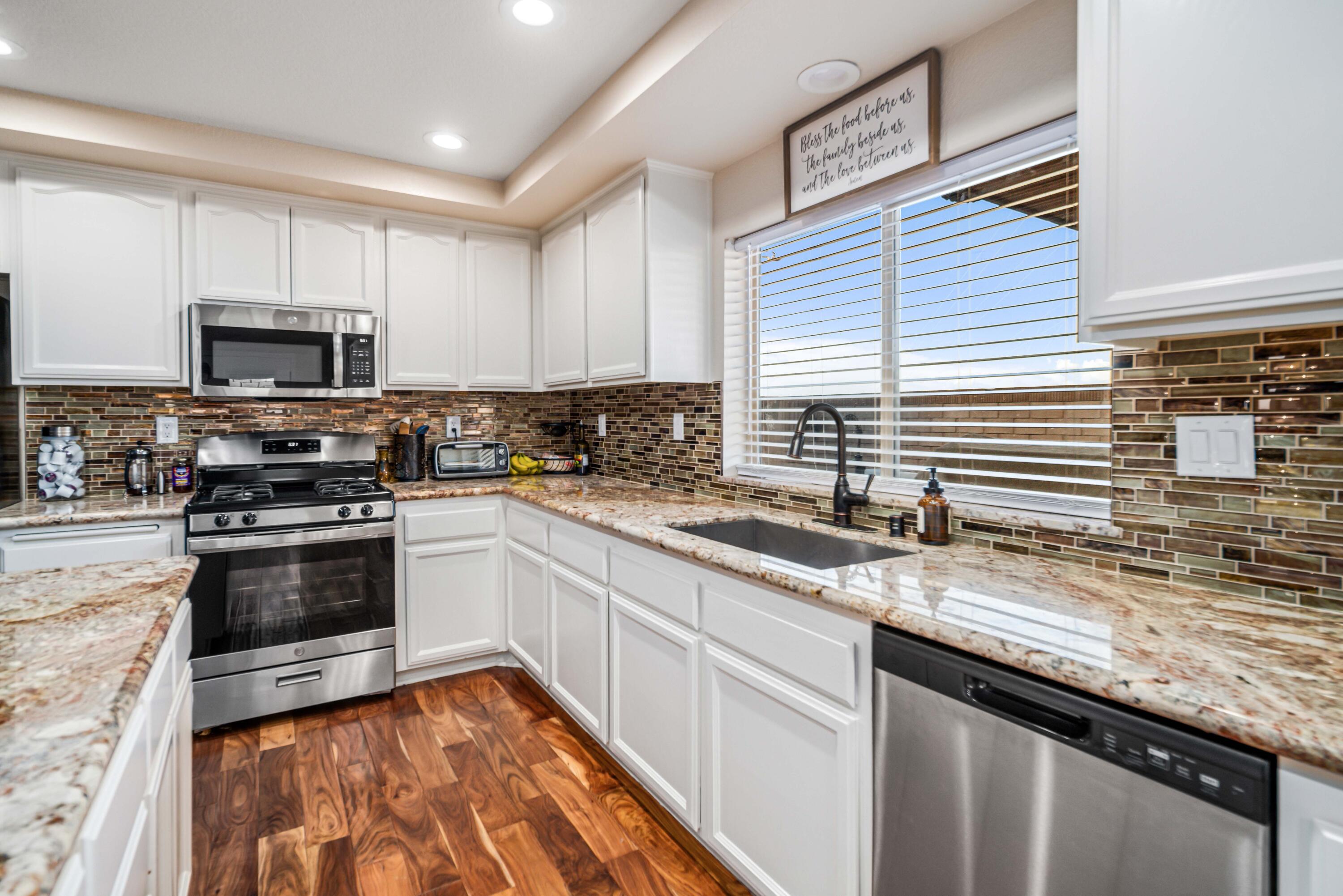 6204 Shadow Hill Drive Lancaster, CA 93536 - Photo 21 of 82 a kitchen with stainless steel appliances granite countertop a sink a stove and cabinets