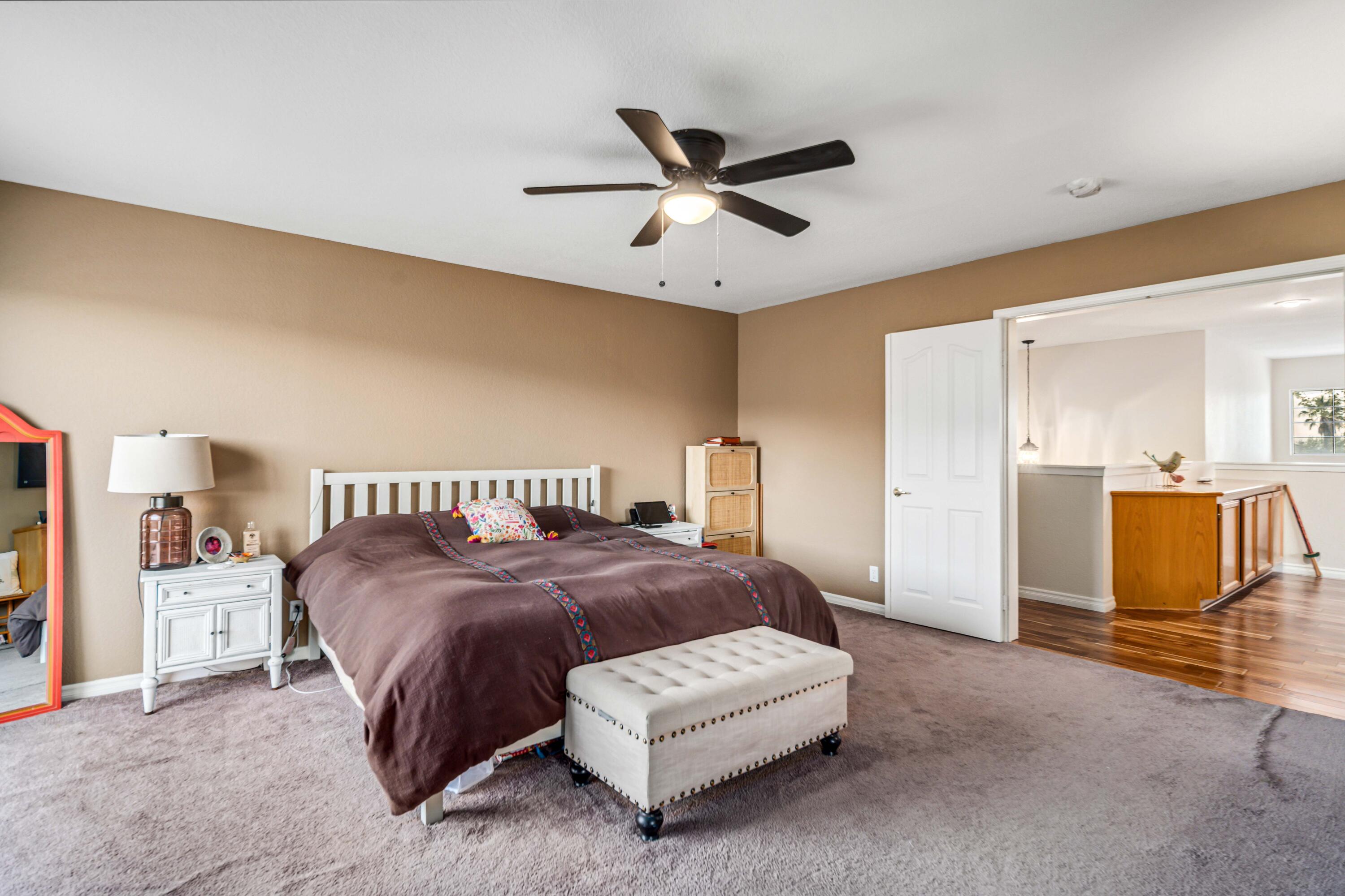 6204 Shadow Hill Drive Lancaster, CA 93536 - Photo 34 of 82 a spacious bedroom with a bed and ceiling fan