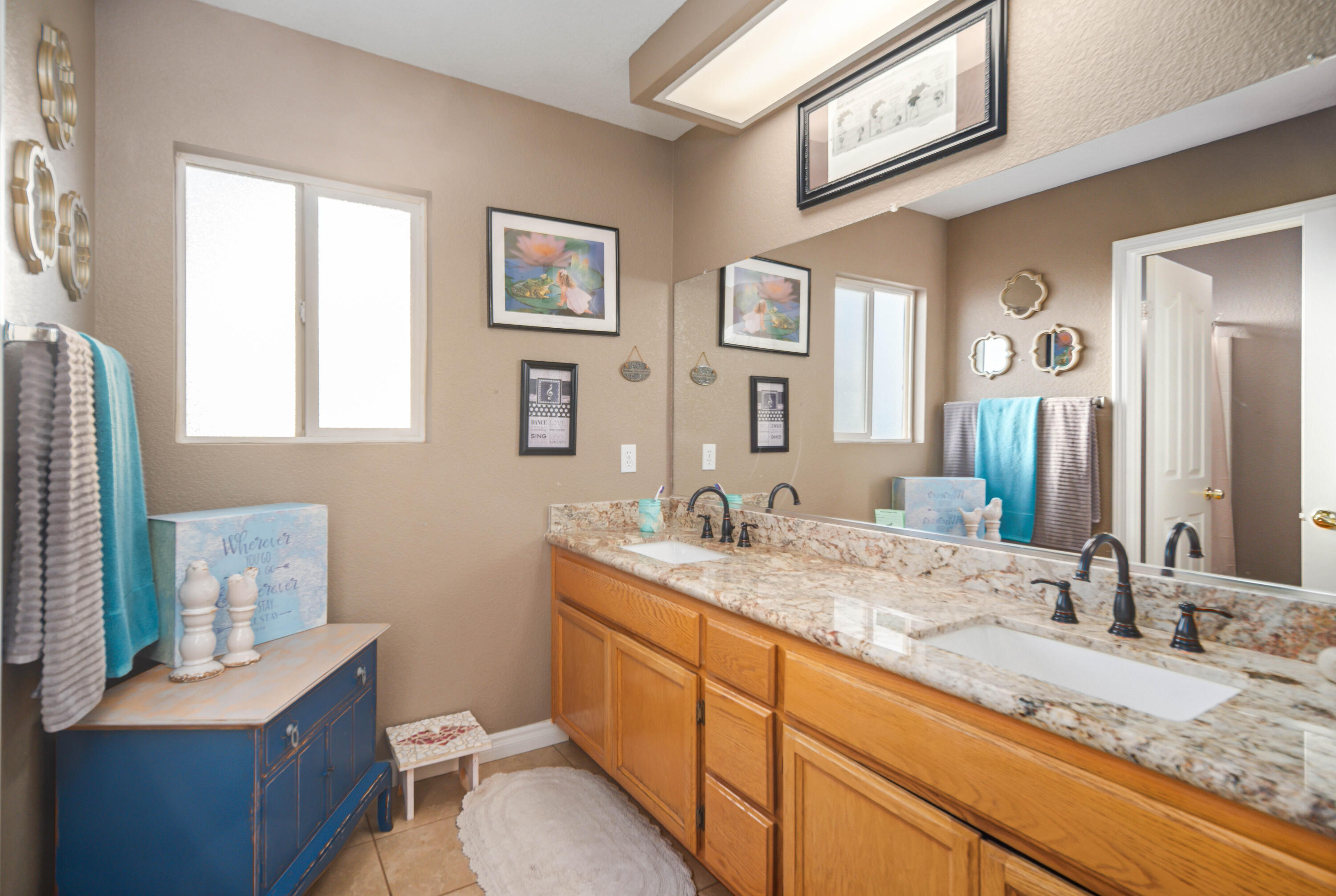 6204 Shadow Hill Drive Lancaster, CA 93536 - Photo 42 of 82 a bathroom with a granite countertop sink mirror vanity and toilet