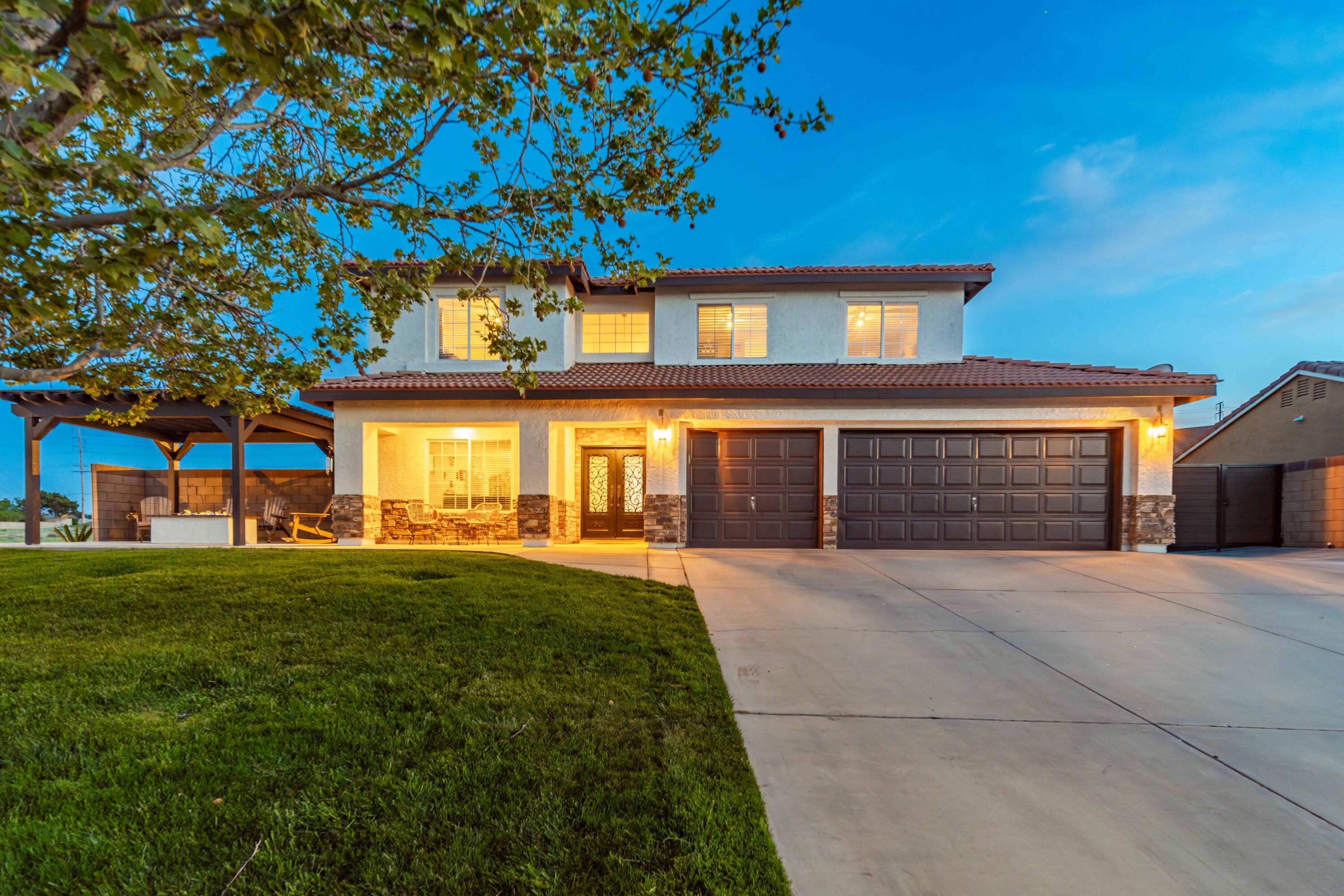 6204 Shadow Hill Drive Lancaster, CA 93536 - Photo 7 of 82 a front view of a house with a yard and garage