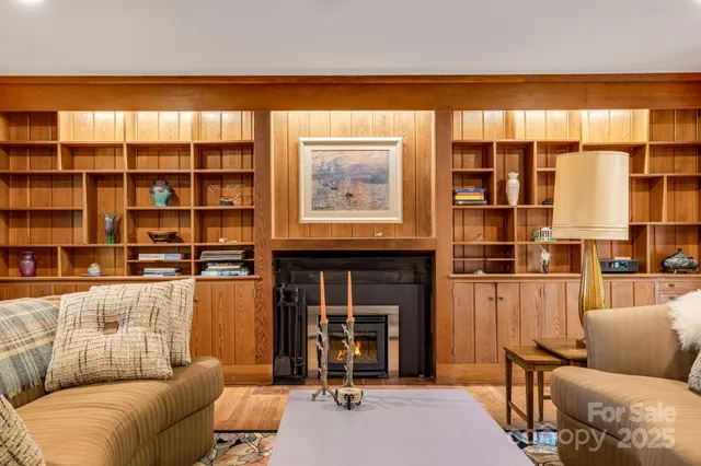 a living room with furniture and large windows