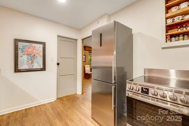 a kitchen with stainless steel appliances a refrigerator and a stove top oven