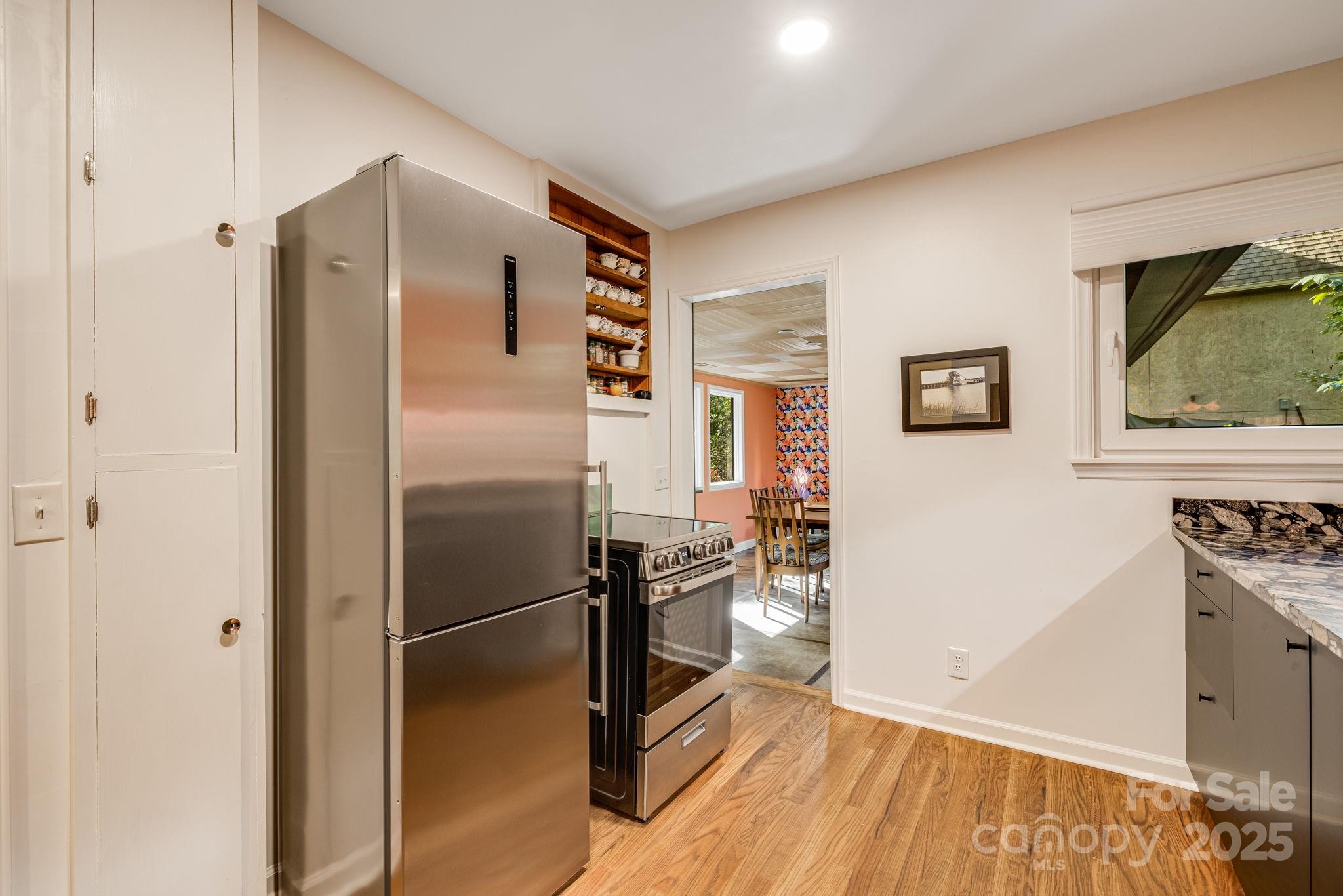 750 Braewick Road Tryon, NC 28782 - Photo 18 of 43 a kitchen with stainless steel appliances a refrigerator and a stove top oven