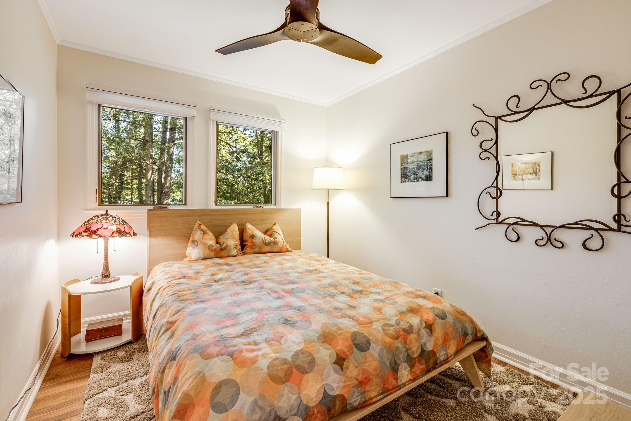 750 Braewick Road Tryon, NC 28782 - Photo 20 of 43 a bedroom with a bed and wooden floor