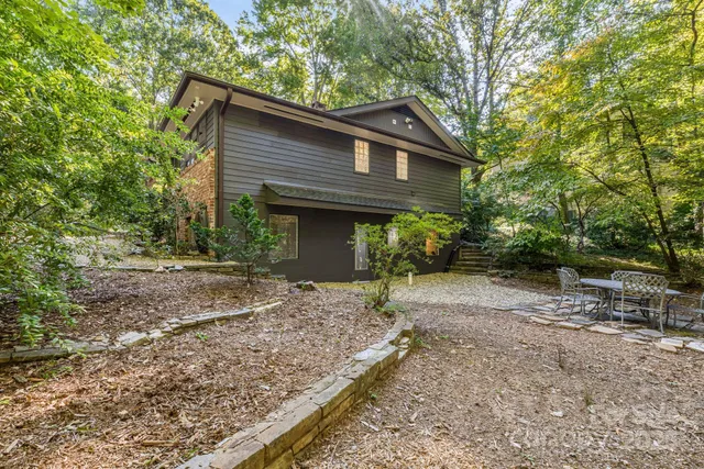 a view of backyard with outdoor seating and green space