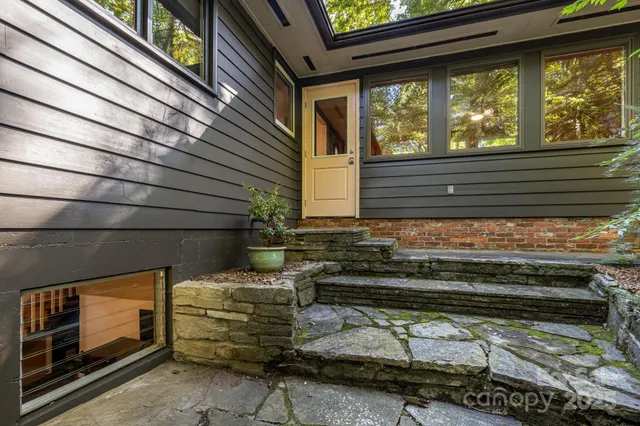 a view of potted plants in backyard of a house