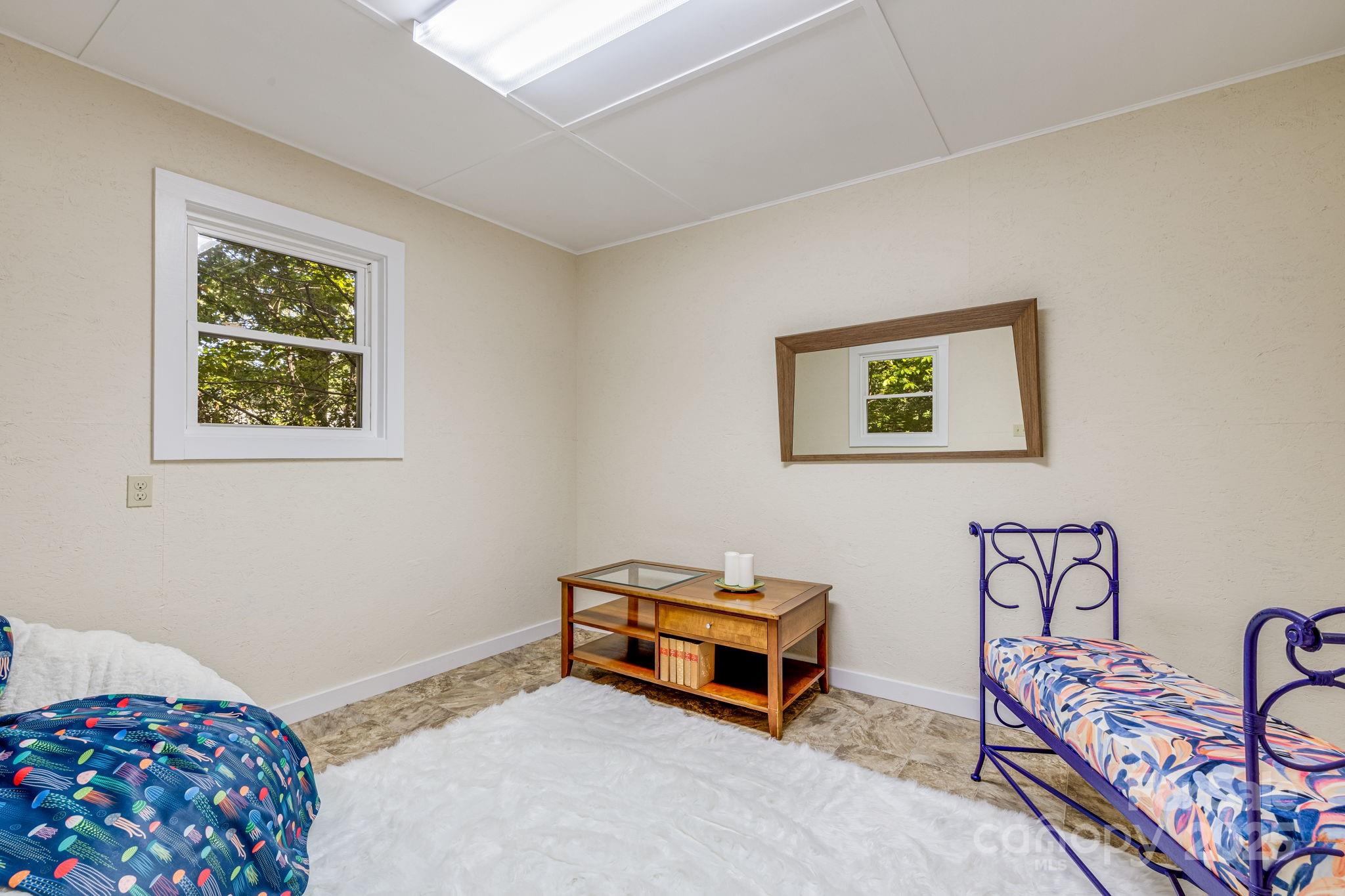 750 Braewick Road Tryon, NC 28782 - Photo 39 of 43 a room with furniture and paintings on the wall