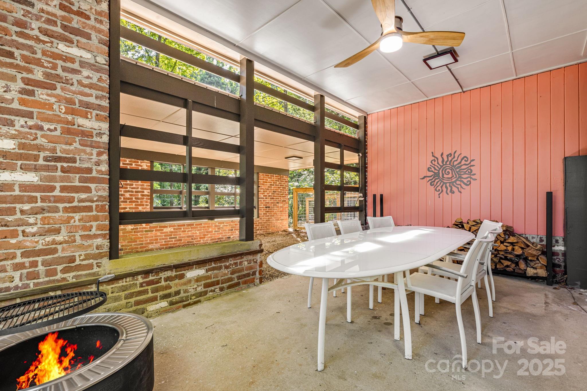 750 Braewick Road Tryon, NC 28782 - Photo 4 of 43 a dining room with furniture and a floor to ceiling window