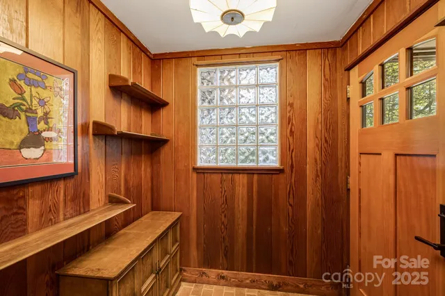 a living room with furniture and large windows
