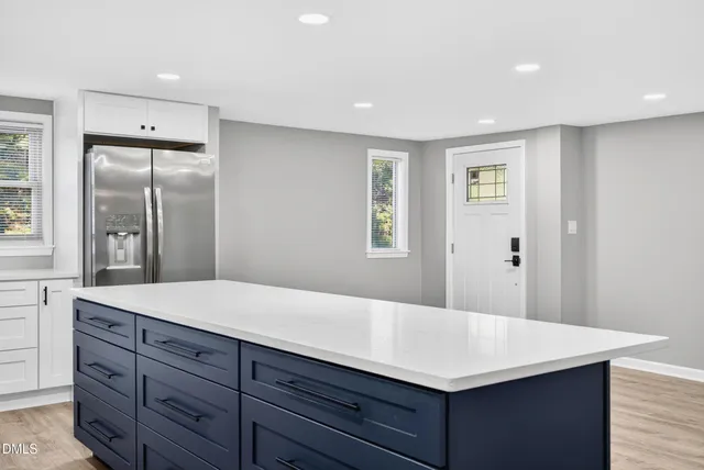 a bathroom with a sink a vanity and a large mirror