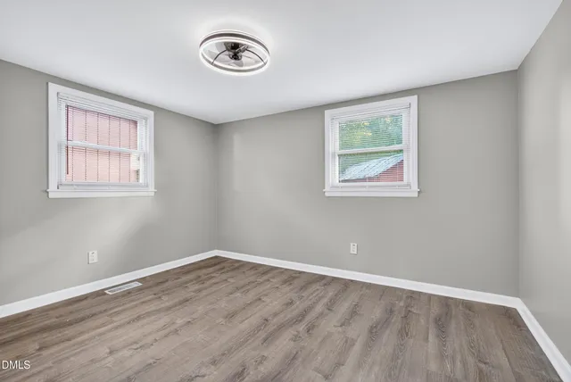 a view of a room with wooden floor and window