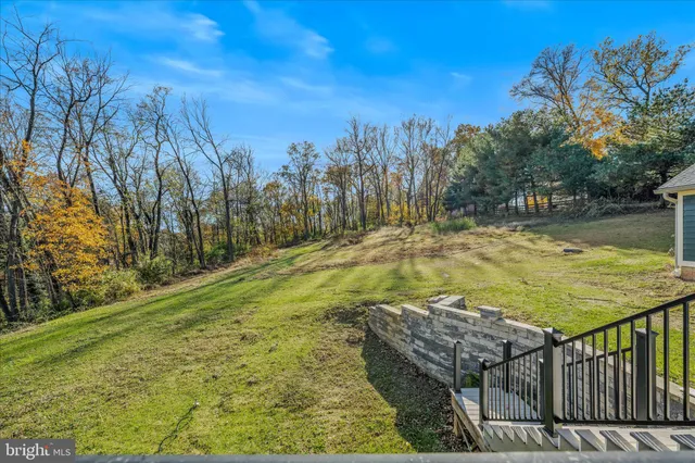 a living room with lots of furniture and baby crib