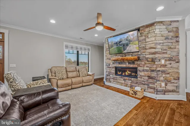 a kitchen with stainless steel appliances granite countertop table chairs sink and wooden floor