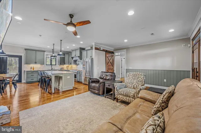 a kitchen with stainless steel appliances granite countertop a stove and a view of dining room