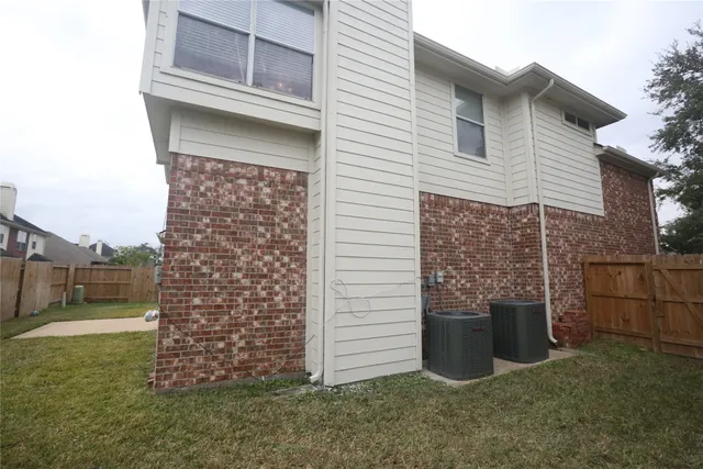 a view of a white house next to a yard
