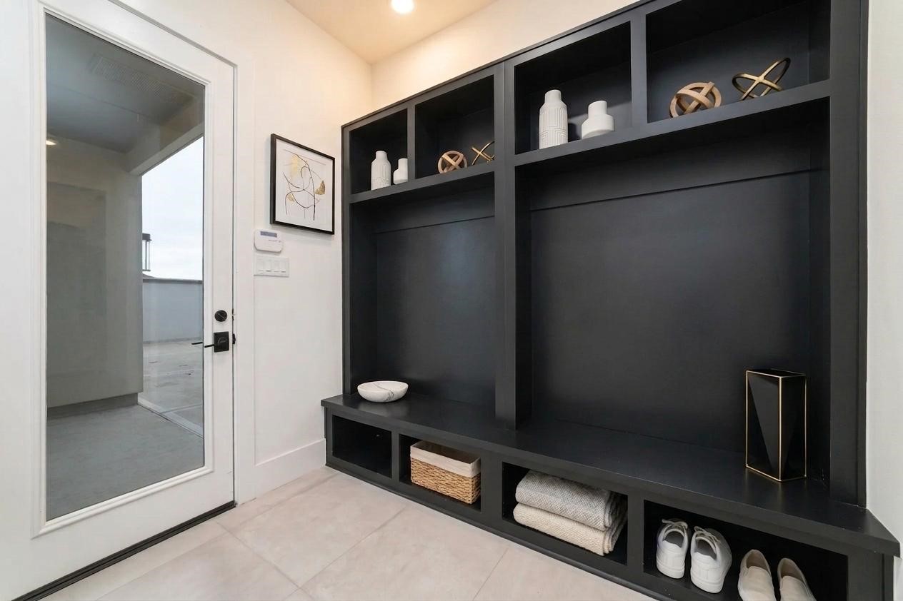 29627 Cir S Rnch Trail Fulshear, TX 77406 - Photo 42 of 50 The mudroom is one of those spaces you'll appreciate every single day. Built-in storage keeps backpacks, shoes, jackets, sports gear, and everyday essentials organized before they ever reach the main living areas.