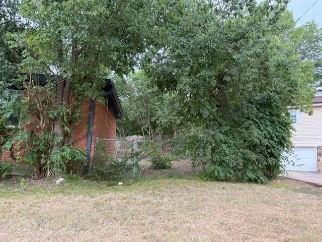 a house is sitting in middle of the garden