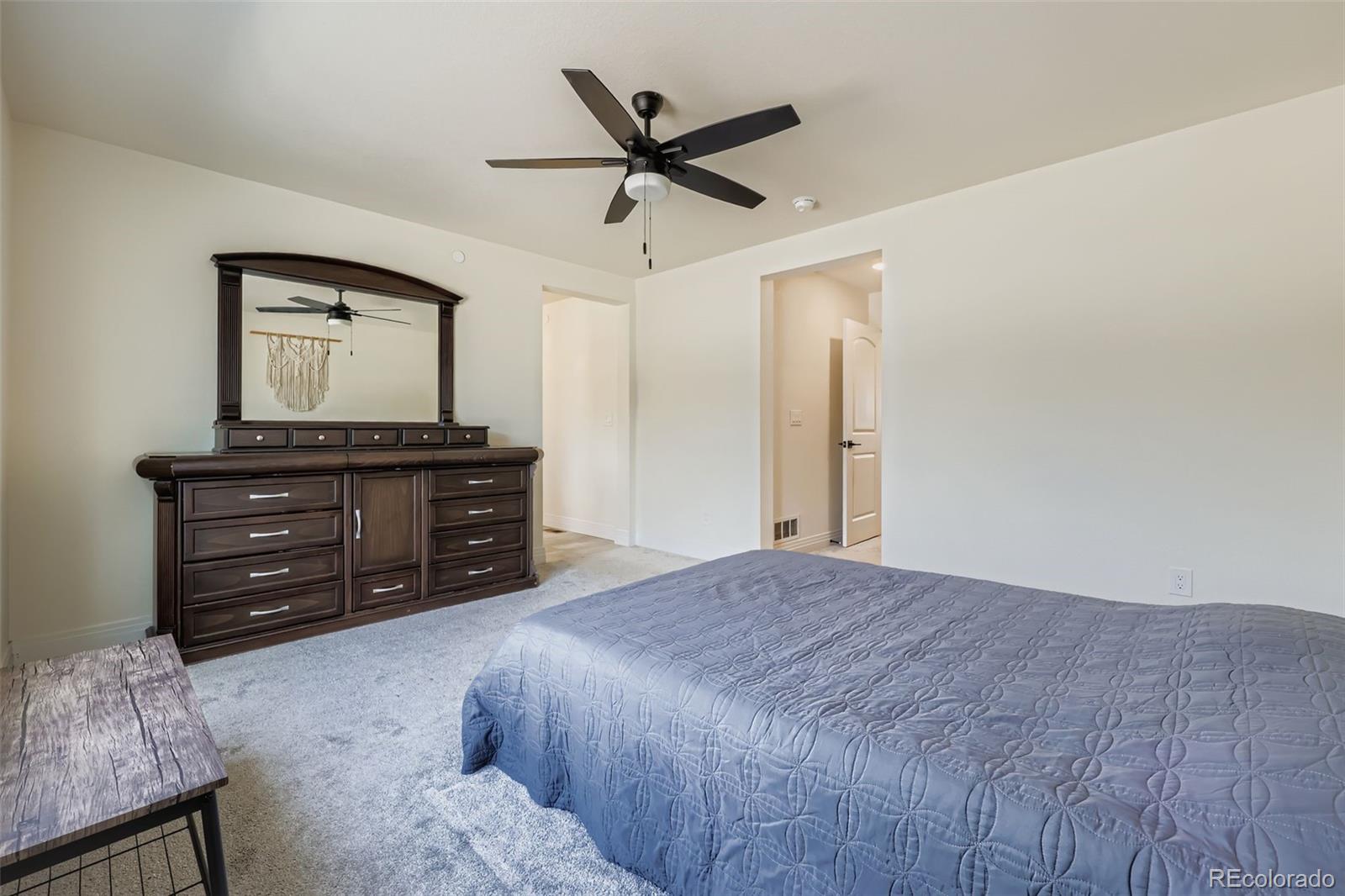1835 Rose Quartz Heights Colorado Springs, CO 80908 - Photo 16 of 31 a bedroom with a bed and a dresser