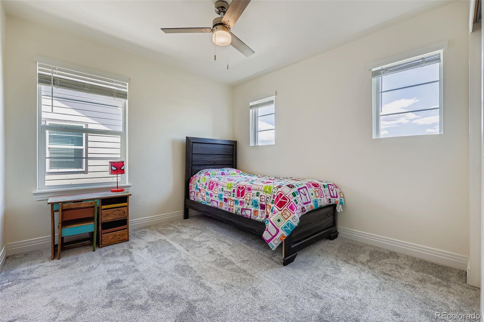 1835 Rose Quartz Heights Colorado Springs, CO 80908 - Photo 20 of 31 a bedroom with a bed and a chandelier