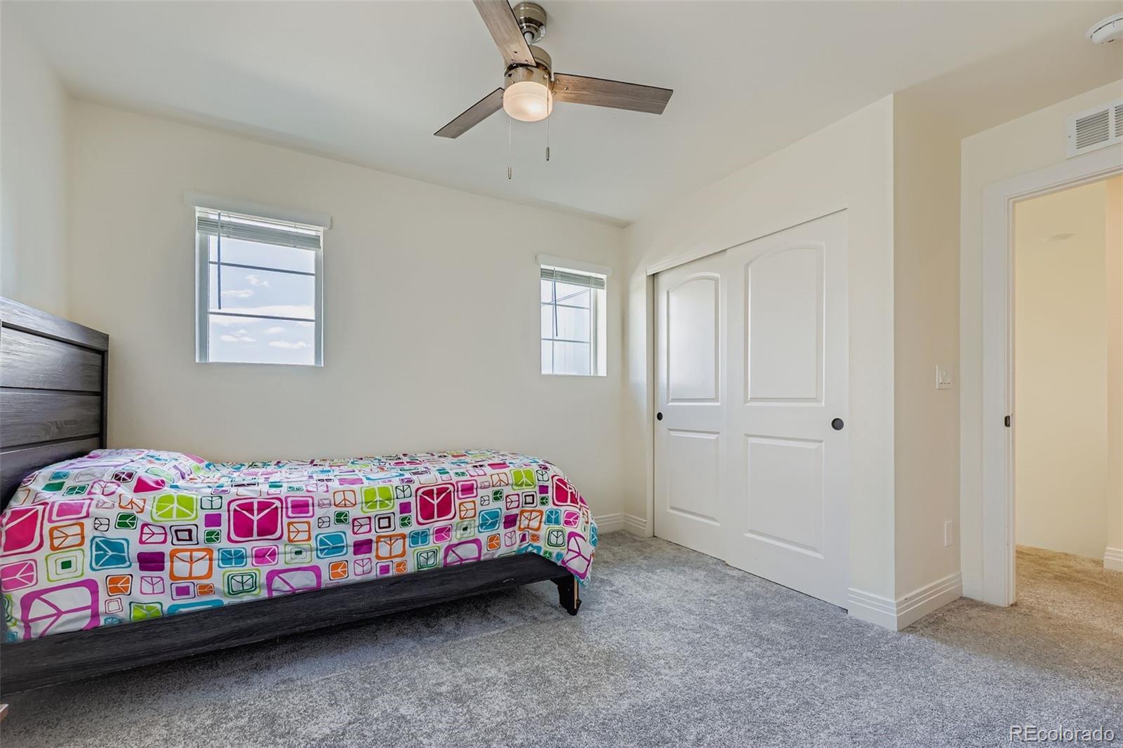 1835 Rose Quartz Heights Colorado Springs, CO 80908 - Photo 21 of 31 a bedroom with a bed and a dresser in it
