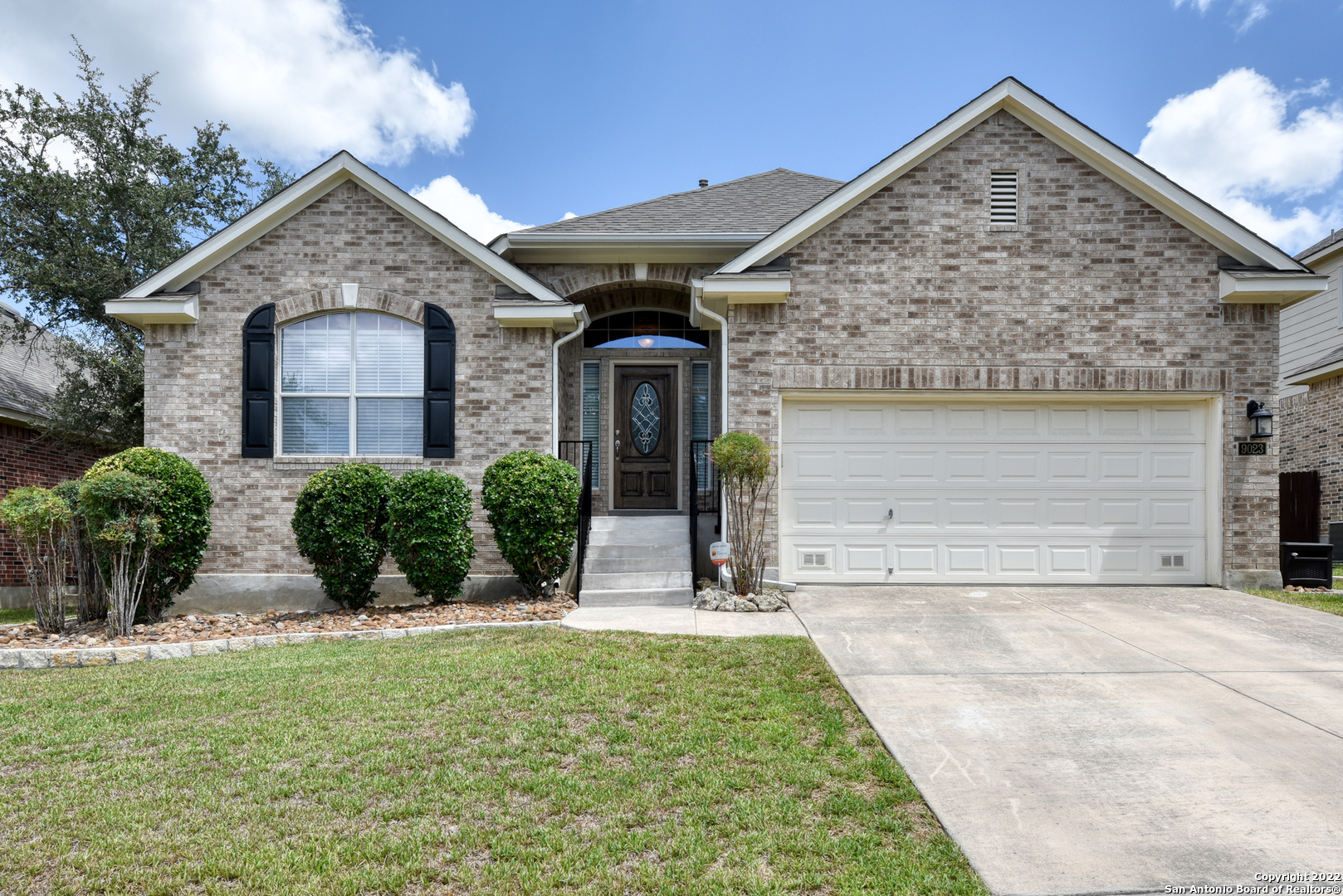 a front view of a house with garden