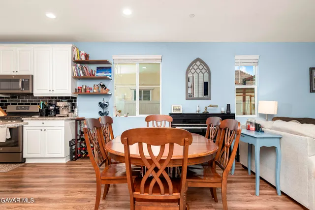a view of a dining room with furniture window and wooden floor