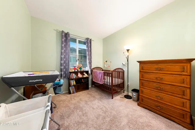 a bedroom with furniture and a large window