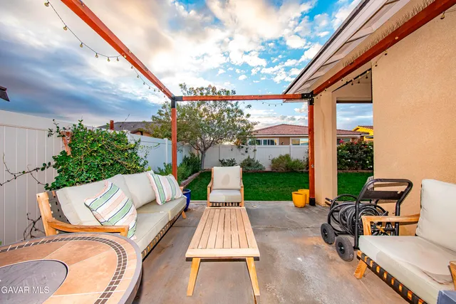 a view of patio with couches table and chairs