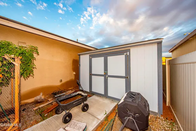 a balcony with furniture and a potted plant