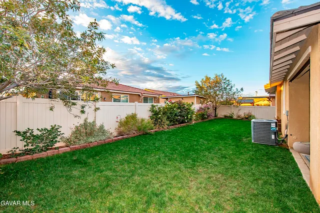 a view of a house with backyard porch and sitting area