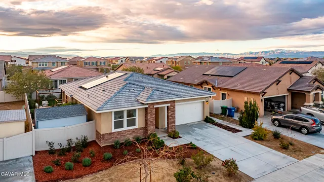 a aerial view of a house with swimming pool and furniture
