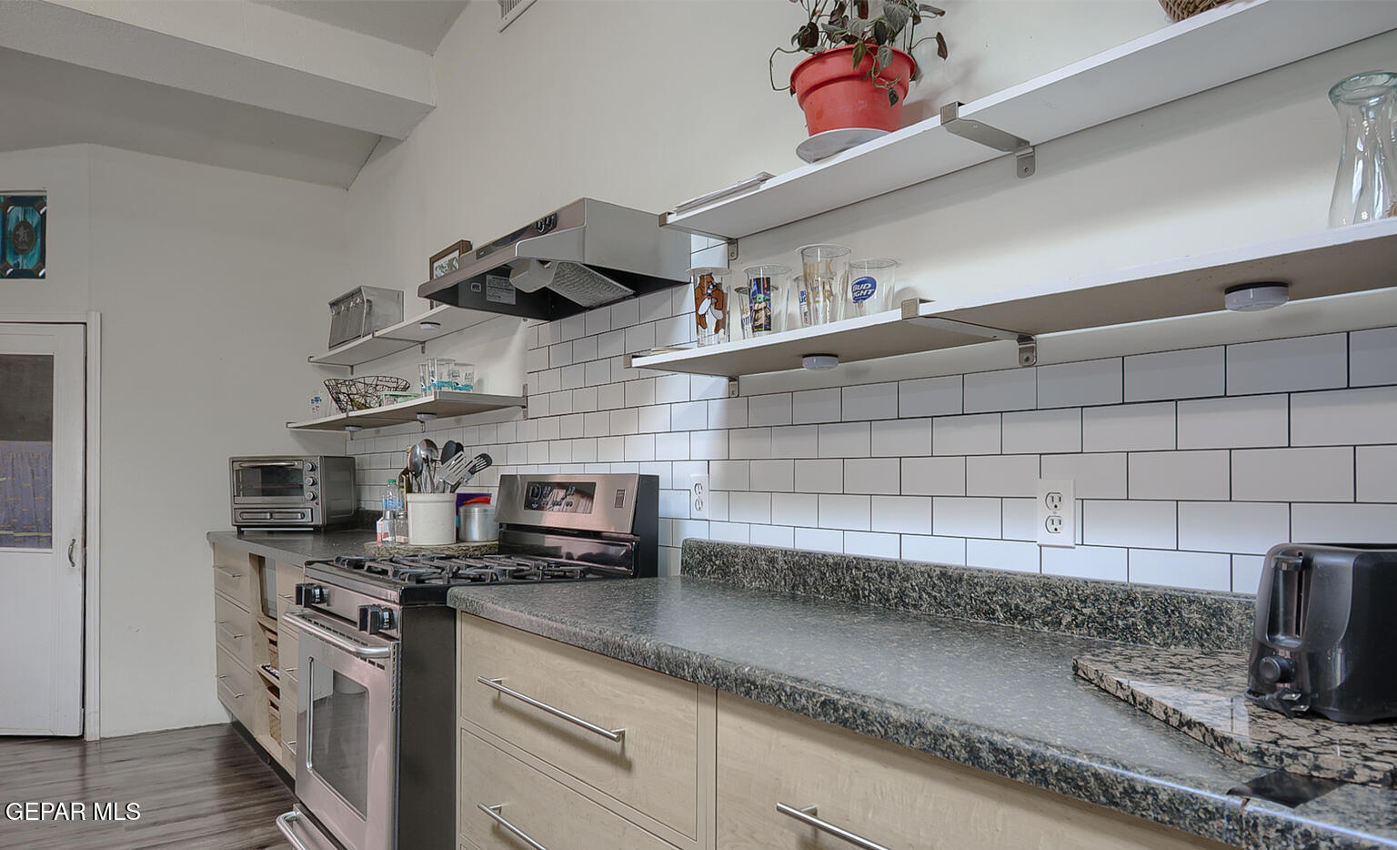 261 Indian Head Road Tornillo, TX 79853 - Photo 13 of 44 a kitchen with stainless steel appliances granite countertop a sink a stove and cabinets
