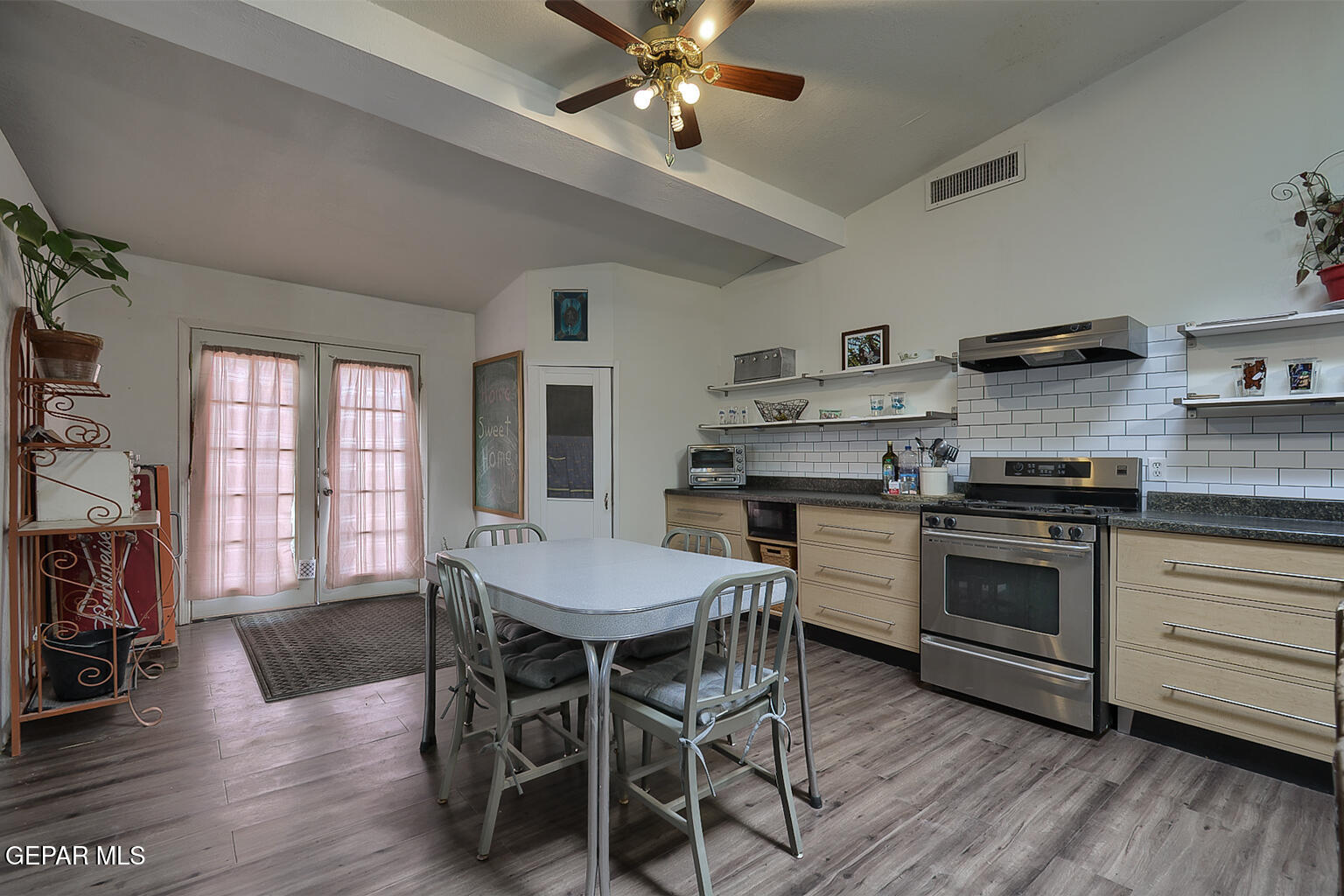 261 Indian Head Road Tornillo, TX 79853 - Photo 17 of 44 a kitchen with stainless steel appliances a dining table chairs stove and cabinets