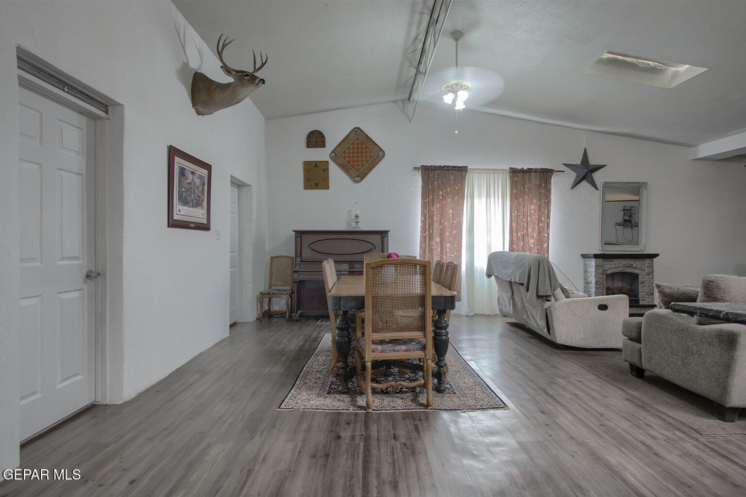 261 Indian Head Road Tornillo, TX 79853 - Photo 18 of 44 a living room with furniture a wooden floor and a chandelier