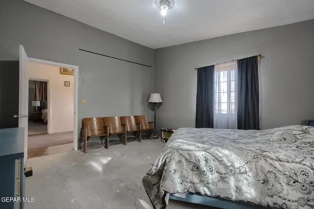 a bedroom with a bed and window