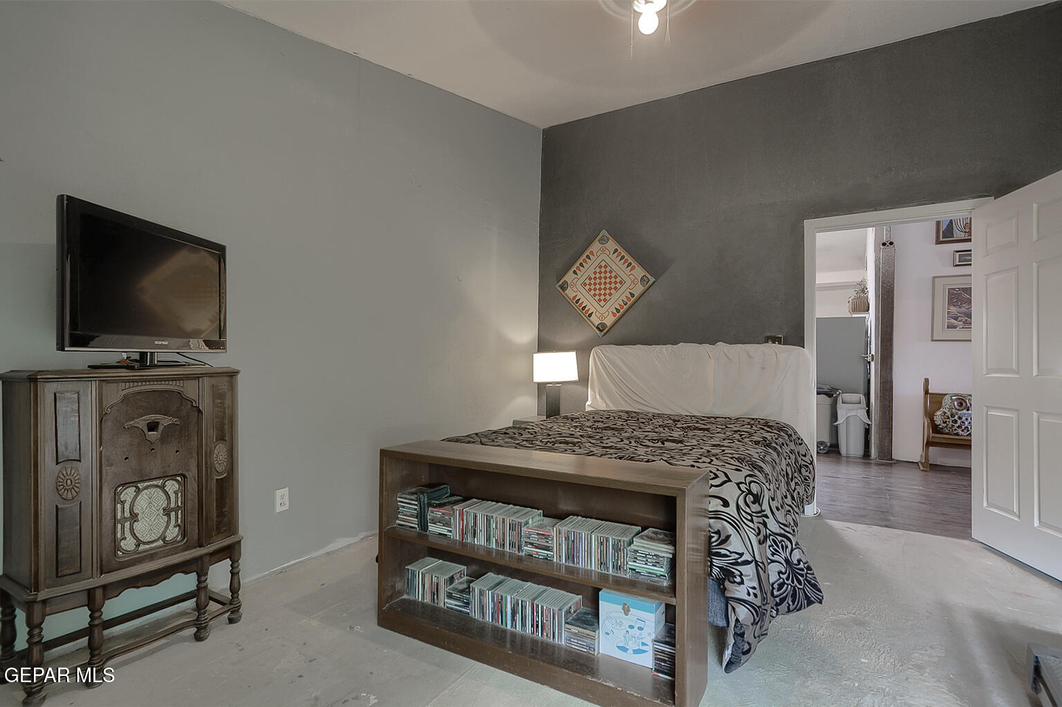 261 Indian Head Road Tornillo, TX 79853 - Photo 26 of 44 a bedroom with a bed a flat tv screen and a chandelier