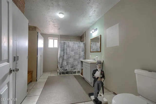 a view of a hallway with workspace and a bathroom