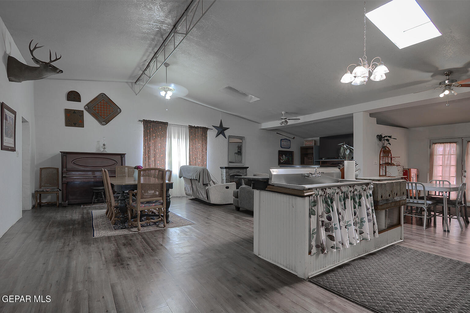 261 Indian Head Road Tornillo, TX 79853 - Photo 43 of 44 a living room with furniture a dining table and a fireplace
