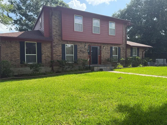 a view of a house with a yard and sitting area