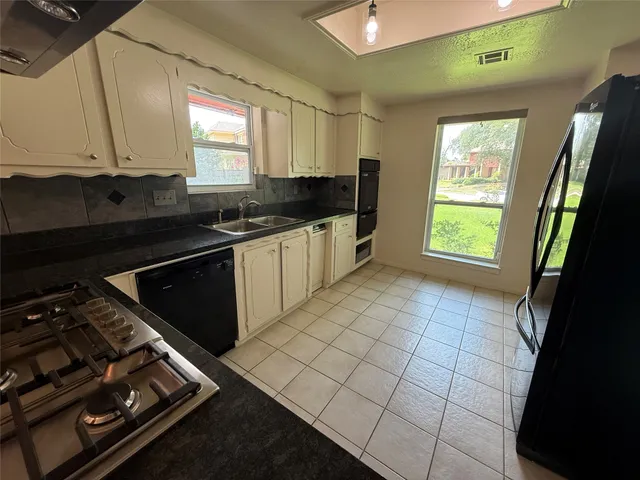 a kitchen with a sink stove and cabinets