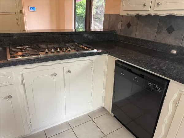 an empty room with a window and a clock