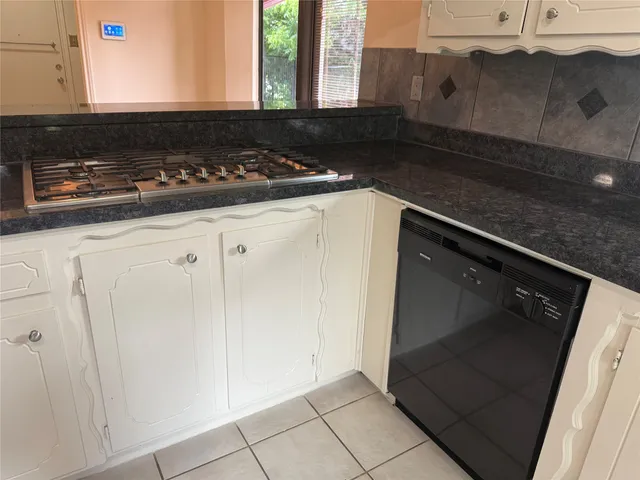 a close view of a stove a microwave and cabinets in the kitchen