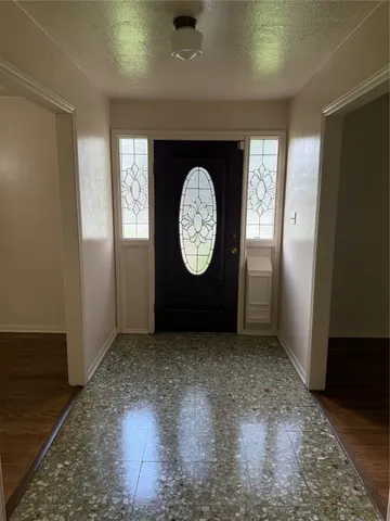 an empty room with a window and a clock