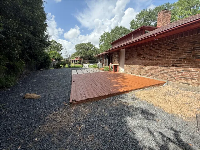 a view of backyard of house with green space