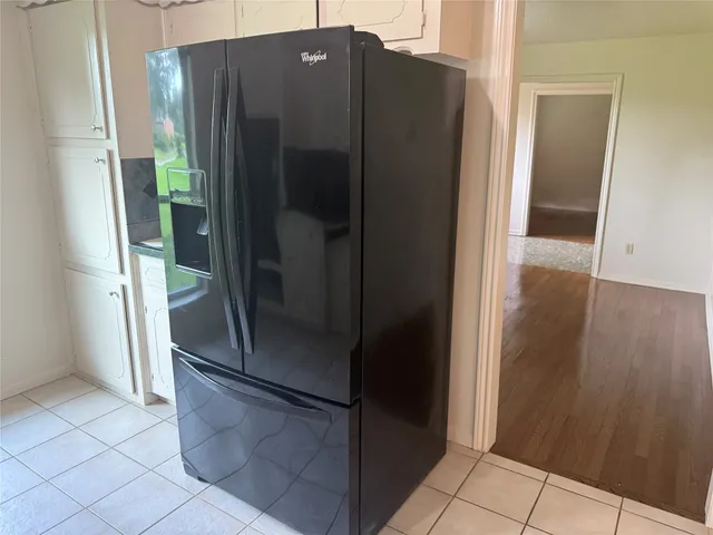 a refrigerator freezer sitting inside of a kitchen