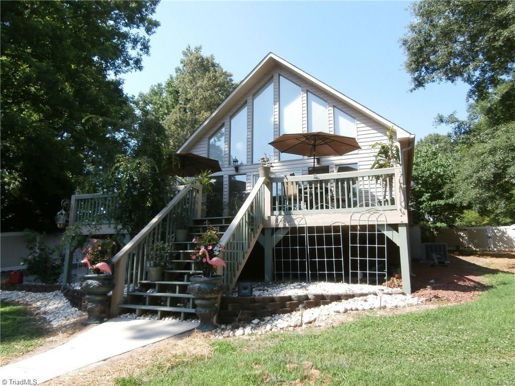 512 Riverview Road Lexington, NC 27292 - Photo 2 of 30 Lakeside view of the property with a deck that spans the entire width of the house and a walkway to the dock.