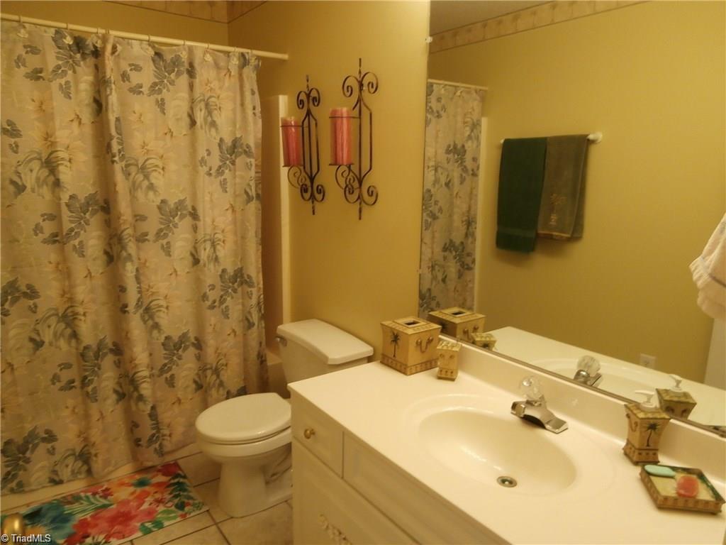 512 Riverview Road Lexington, NC 27292 - Photo 19 of 30 Main level hall bathroom with tile flooring, counter space, and a combination shower/tub