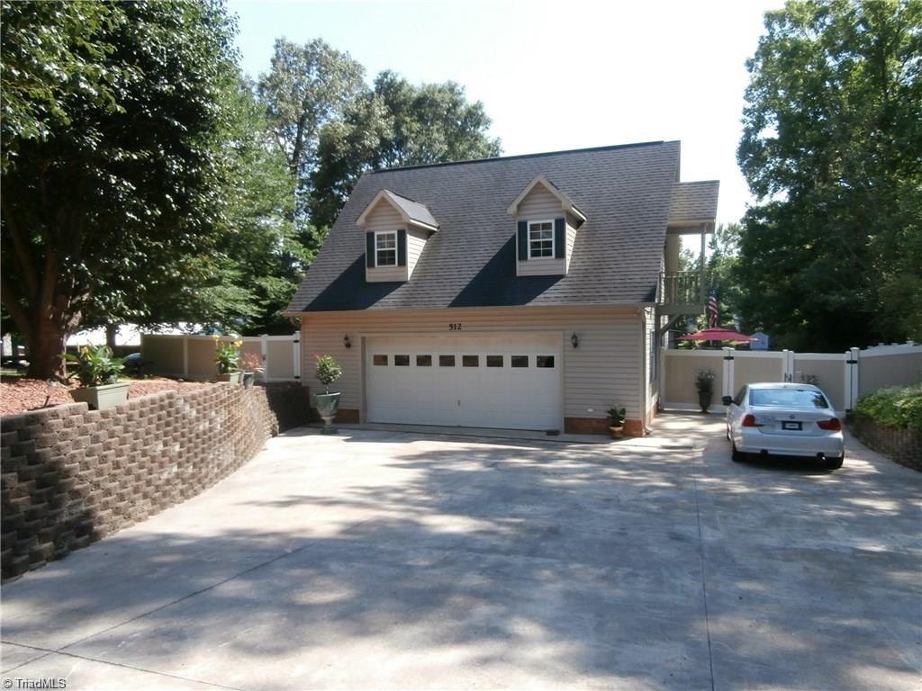 512 Riverview Road Lexington, NC 27292 - Photo 3 of 30 Impeccably maintained waterfront home with a 2 car garage, and plenty of off street parking.