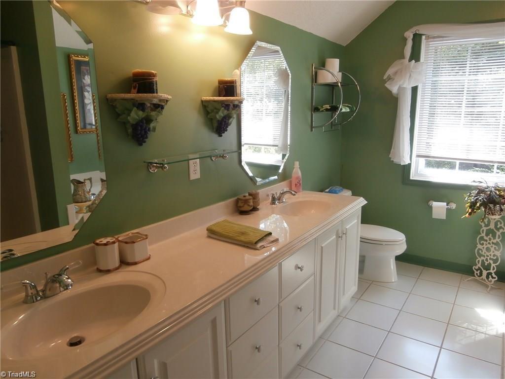 512 Riverview Road Lexington, NC 27292 - Photo 23 of 30 Spacious upper level bathroom, can be master bath with 2 sinks, spacious shower, garden tub, and tile flooring.