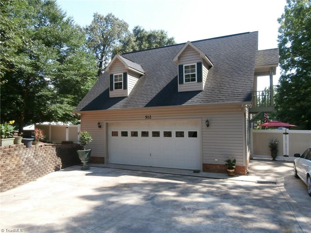 512 Riverview Road Lexington, NC 27292 - Photo 28 of 30 Vinyl low maintenance exterior and privacy fencing. Wide driveway and impeccable landscaping.